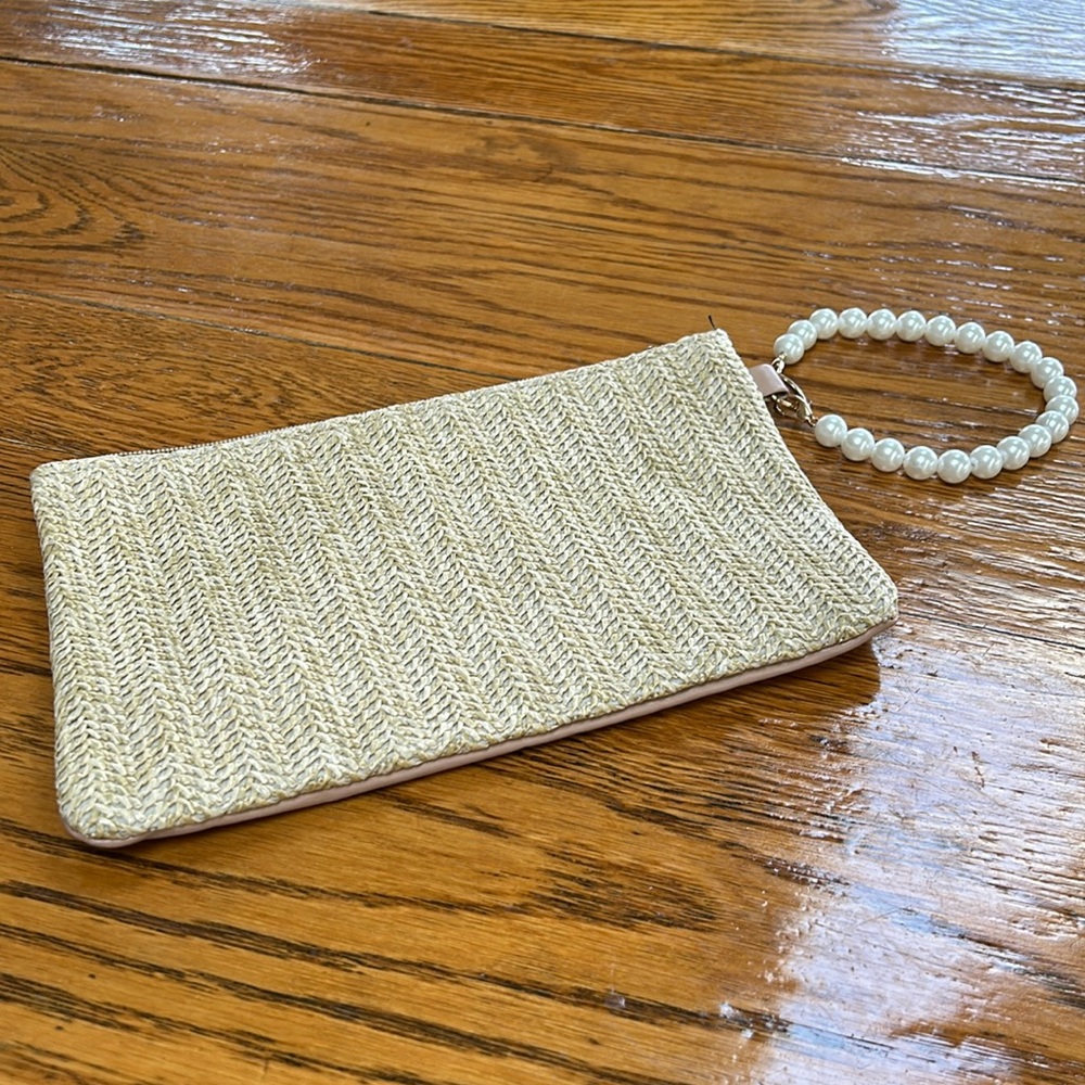 No brand tag. Small zip close bag with pearl bracelet handle.